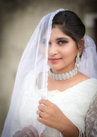 Portrait of young woman wearing wedding dress