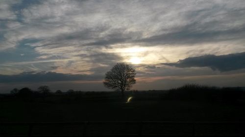 Scenic view of landscape against cloudy sky