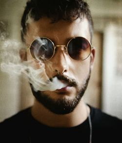 Close-up portrait of young man wearing sunglasses