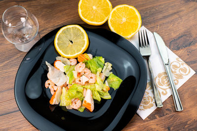 High angle view of fruits in plate on table