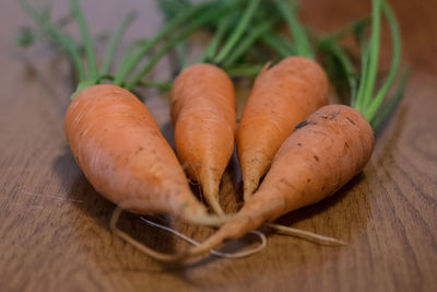 Close-up of carrots on wooden table