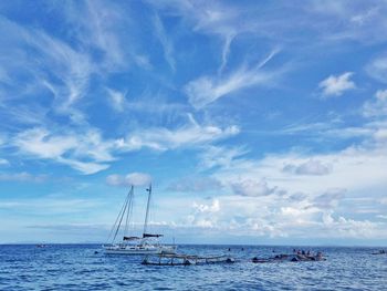 Sailboat sailing in sea against sky