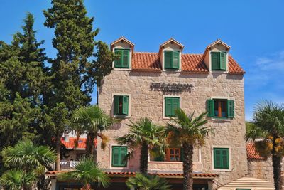 Low angle view of residential building against blue sky