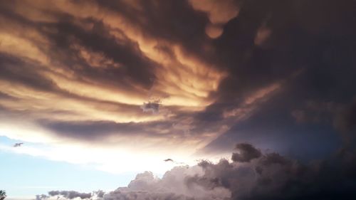 Low angle view of dramatic sky during sunset