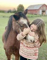 Girl loving her pony