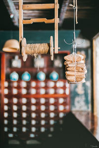 Stacked pouches and spool of thread hanging at store