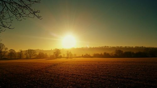 Scenic view of field against sky during sunset