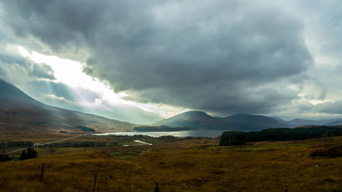 Scenic view of mountains against cloudy sky