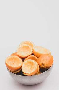 Close-up of orange fruit against white background