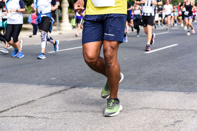 Low section of people running on road