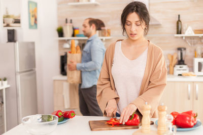 Man and woman standing on table