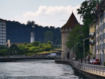 Bridge over river by buildings in town