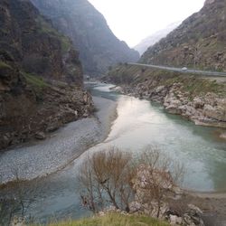 High angle view of river amidst trees against sky