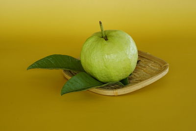 Close-up of fruit against green background