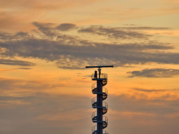 Low angle view of silhouette tower against sky during sunset