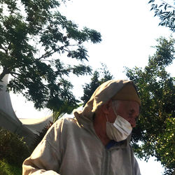 Low angle view of man standing against sky