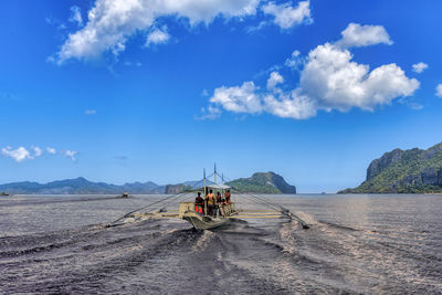 People on desert against sky