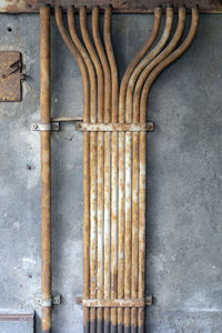 View of rusty pipe lines on concrete wall