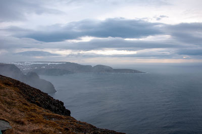Scenic view of sea and mountains against sky