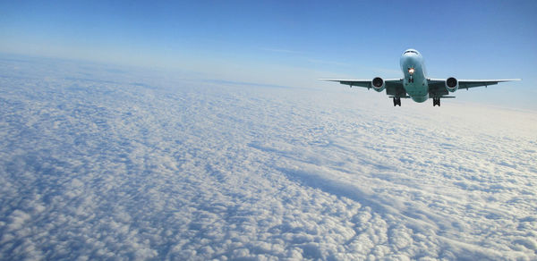 Low angle view of airplane flying in sky