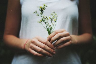 Close-up of woman holding flower bouquet