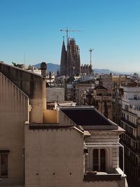 Buildings in city against clear sky