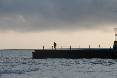 Scenic view of sea against cloudy sky