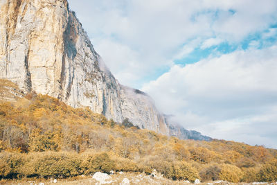 Low angle view of rock formation against sky