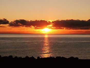 Scenic view of sea against romantic sky at sunset