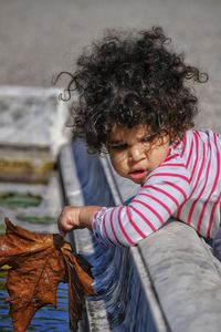 Full length of girl holding leaf