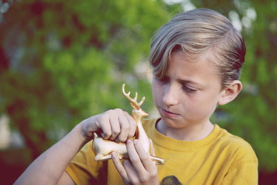 Portrait of boy holding outdoors