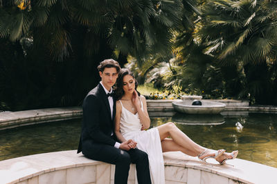 A beautiful couple in love, bride and groom in wedding clothes, walk and pose in the park in nature