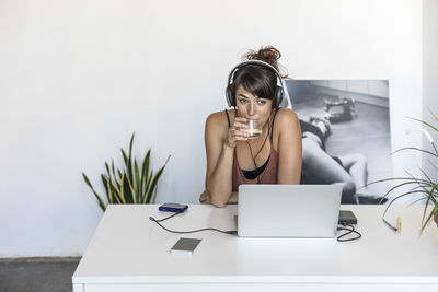 Young woman using laptop at home