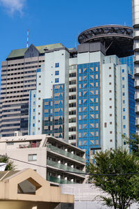 Low angle view of buildings against blue sky .broadcasting center akasaka minato city tokyo, japan