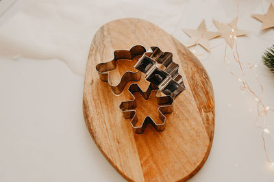 Metal molds for cookies in  form of a man, a christmas tree of snowflakes on a wooden folding board