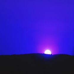 Low angle view of silhouette mountain against sky at night