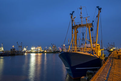 Fishing boats in the harbor from lauwersoog in the netherlands at night