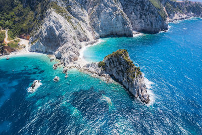 High angle view of rocks on sea shore