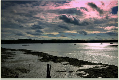 Scenic view of lake against cloudy sky