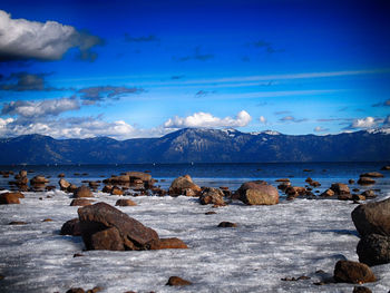 Scenic view of lake against cloudy sky