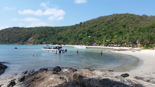 People on beach against sky