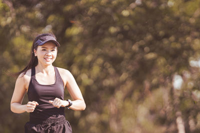 Portrait of smiling woman standing outdoors