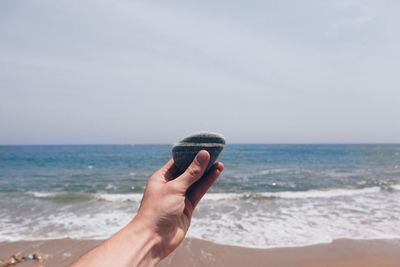 Cropped image of people on beach