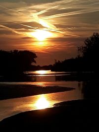 Scenic view of lake against romantic sky at sunset