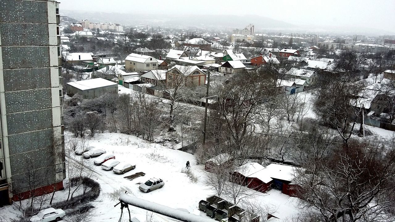 building exterior, architecture, snow, built structure, winter, cold temperature, tree, high angle view, season, city, residential building, residential structure, covering, house, cityscape, residential district, weather, mountain, landscape, day