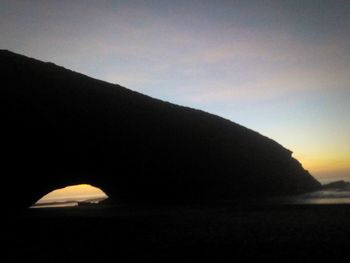 Scenic view of silhouette mountain against sky at sunset