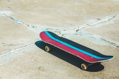 High angle view of skateboard on sand