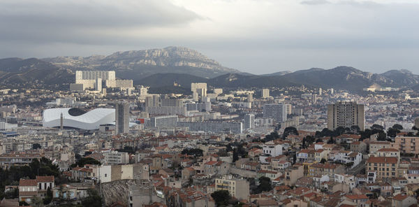 High angle view of city against cloudy sky