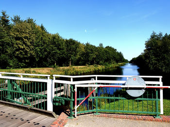 Built structure by railing against blue sky
