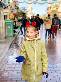 Girl wearing warm clothing standing on street